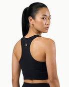 Women's Apex Crop Compression top in Black, back view on model