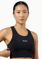 Women's Apex Crop Compression top in Black, front view on model