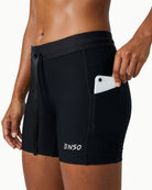 Women's Contour Short in Black, front view showing waterproof phone pocket