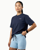 Unisex Origin Tee in Navy, front view on female model
