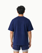 Unisex Origin Tee in Navy, back view on model